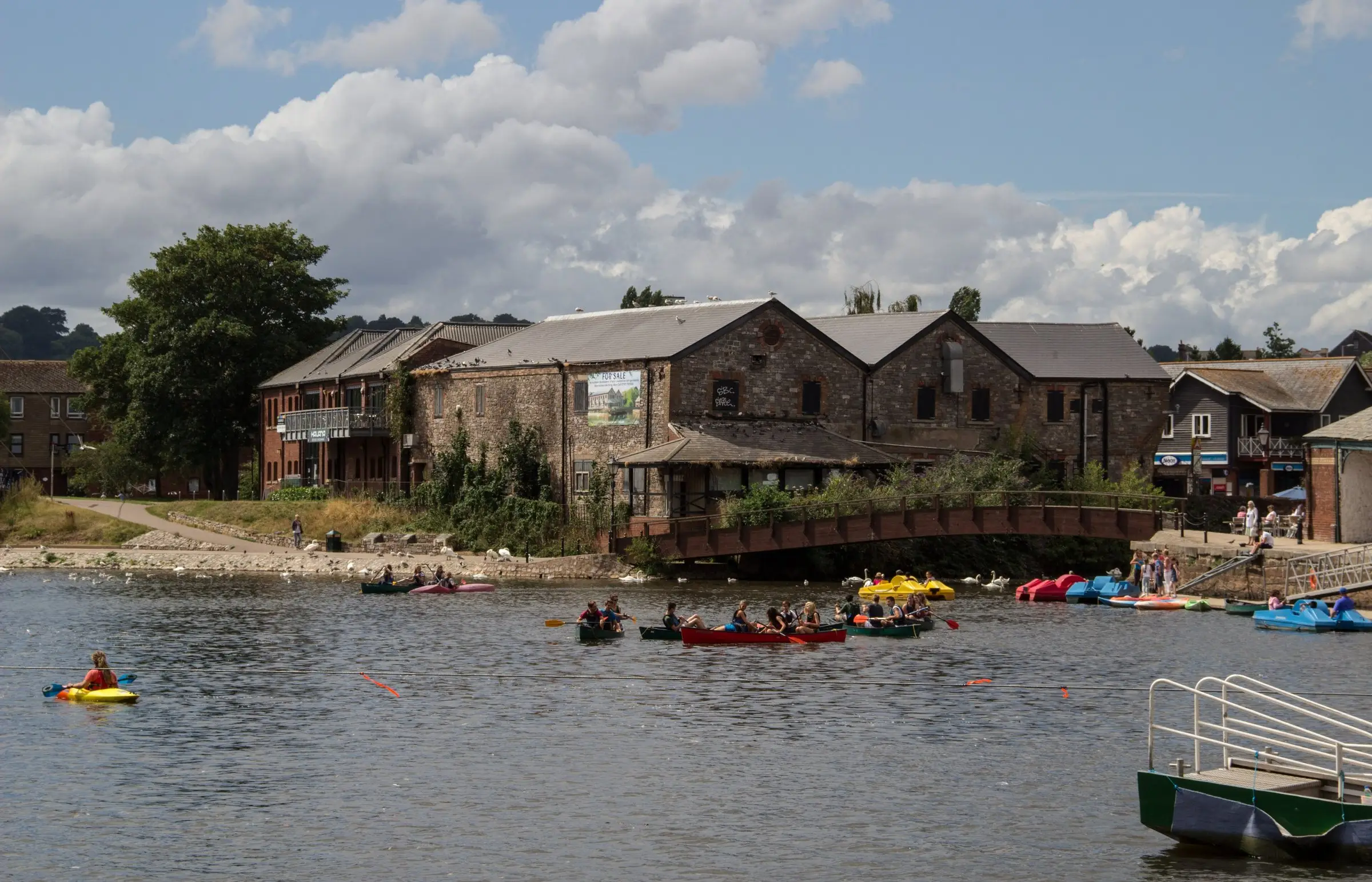 Exeter Quay on the River Exe, the old warehouses on the far bank and canoes on the water